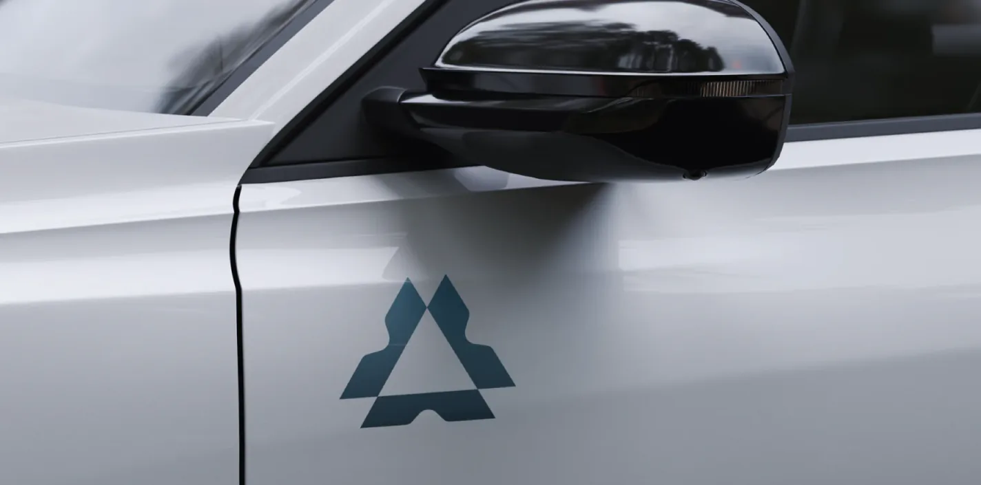 The AgenticOS mark as a small decal on a white car door
