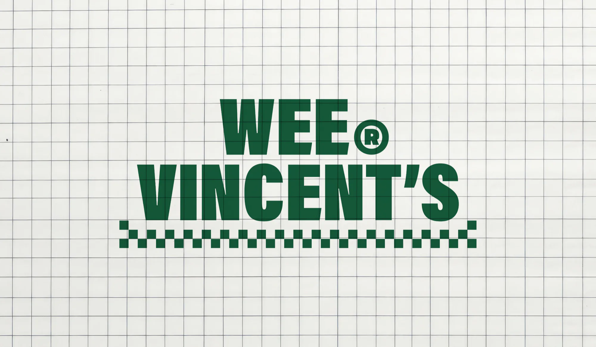 The stacked wordmark cut in vinyl on a tiled wall, a checkerboard rule beneath it